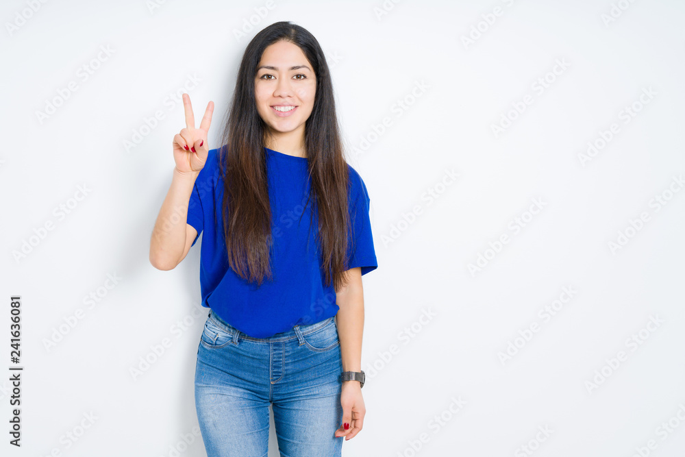Beautiful brunette woman over isolated background showing and pointing up with fingers number two while smiling confident and happy. Beautiful brunette woman over isolated background showing and pointing up with fingers number two while smiling confident and happy.