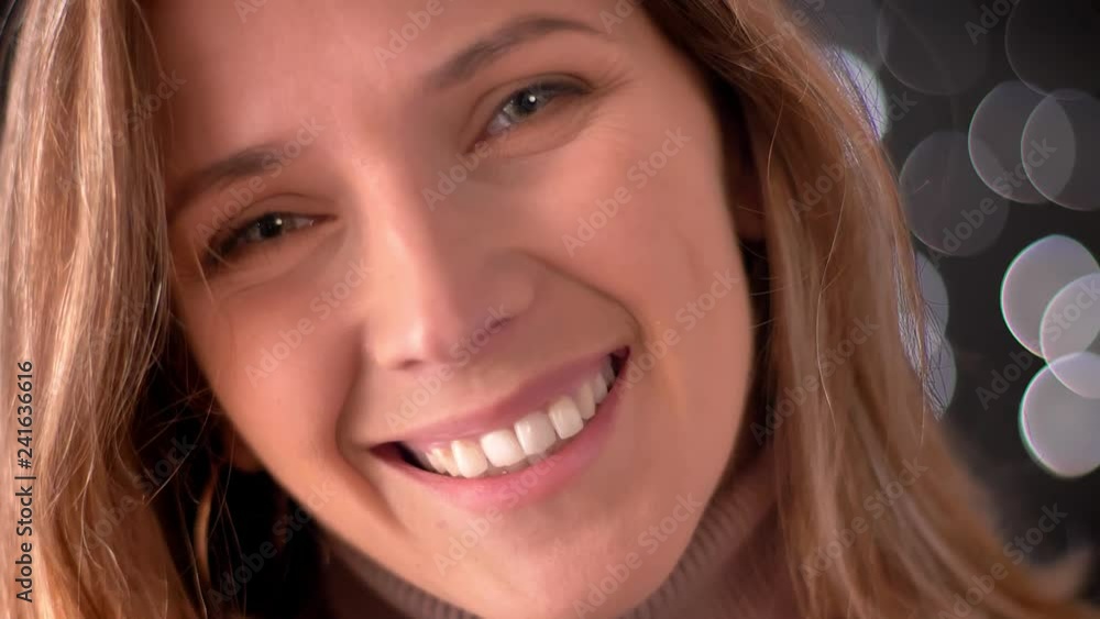 Closeup macro portrait of happy stunning caucasian female face looking straight at camera and smiling Closeup macro portrait of happy stunning caucasian female face looking straight at camera and smiling