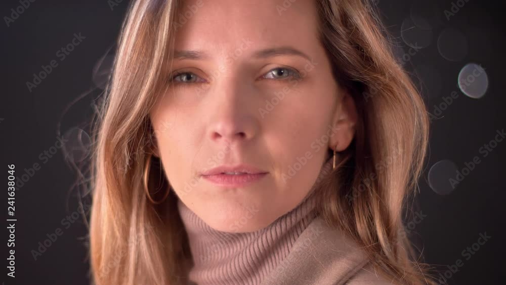Closeup portrait of attractive adult caucasian female looking straight at camera. Front view of beautiful woman face Closeup portrait of attractive adult caucasian female looking straight at camera. Front view of beautiful woman face