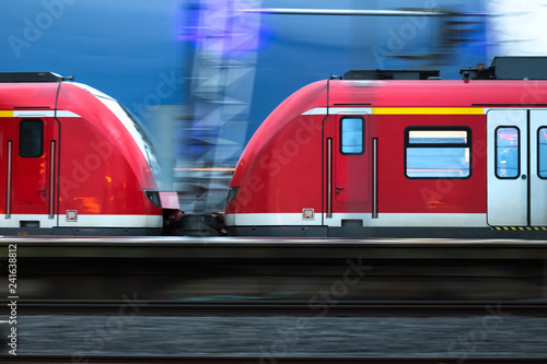red passenger train in the evening