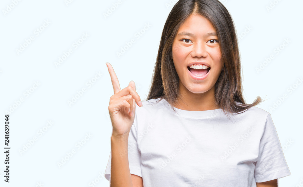 Young asian woman over isolated background pointing finger up with successful idea. Exited and happy. Number one. Young asian woman over isolated background pointing finger up with successful idea. Exited and happy. Number one.