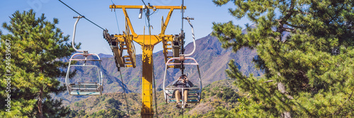 A man rides the cable car to the Great Wall of China BANNER, LONG FORMAT