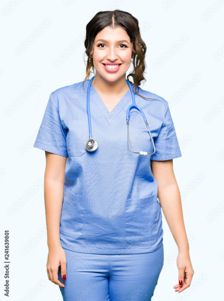 Young adult doctor woman wearing medical uniform with a happy and cool smile on face. Lucky person. Young adult doctor woman wearing medical uniform with a happy and cool smile on face. Lucky person.