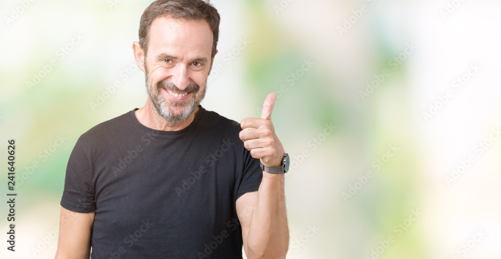Handsome middle age hoary senior man over isolated background doing happy thumbs up gesture with hand. Approving expression looking at the camera with showing success. Handsome middle age hoary senior man over isolated background doing happy thumbs up gesture with hand. Approving expression looking at the camera with showing success.