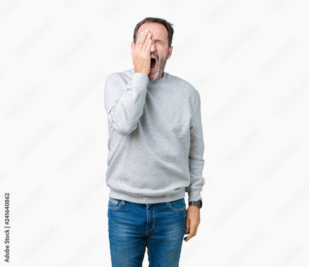 Handsome middle age senior man wearing a sweatshirt over isolated background Yawning tired covering half face, eye and mouth with hand. Face hurts in pain. Handsome middle age senior man wearing a sweatshirt over isolated background Yawning tired covering half face, eye and mouth with hand. Face hurts in pain.