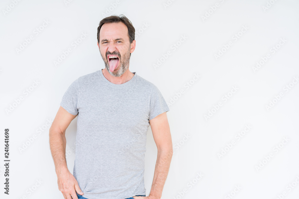 Handsome senior man over isolated background sticking tongue out happy with funny expression. Emotion concept. Handsome senior man over isolated background sticking tongue out happy with funny expression. Emotion concept.