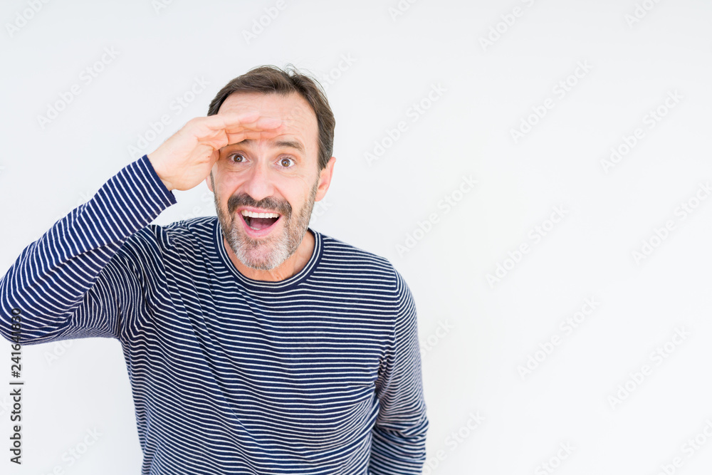 Handsome senior man over isolated background very happy and smiling looking far away with hand over head. Searching concept. Handsome senior man over isolated background very happy and smiling looking far away with hand over head. Searching concept.