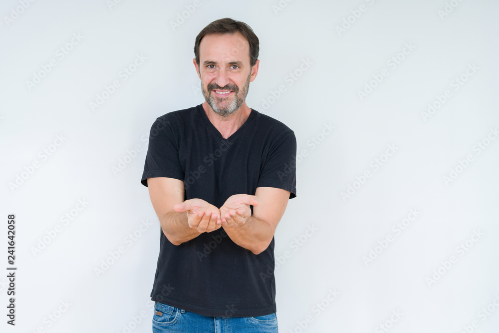 Senior man over isolated background Smiling with hands palms together receiving or giving gesture. Hold and protection Senior man over isolated background Smiling with hands palms together receiving or giving gesture. Hold and protection