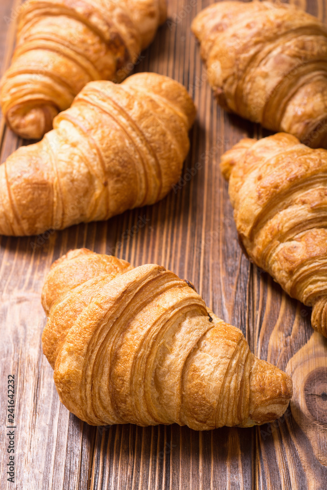 Croissants on wooden background