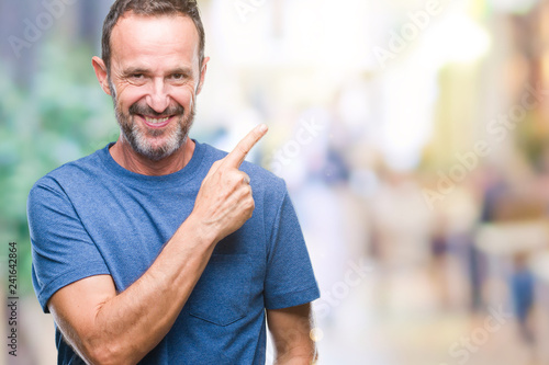 Middle age hoary senior man over isolated background cheerful with a smile of face pointing with hand and finger up to the side with happy and natural expression on face looking at the camera.