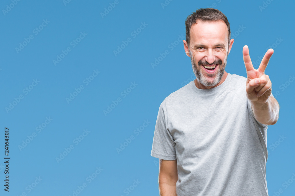 Middle age senior hoary man over isolated background smiling with happy face winking at the camera doing victory sign. Number two. Middle age senior hoary man over isolated background smiling with happy face winking at the camera doing victory sign. Number two.