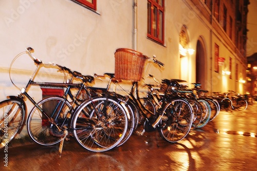 Out of focus concept photo. Bikes on the night street on the blur background