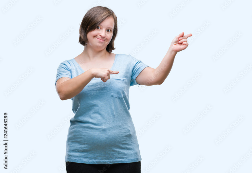 Young adult woman with down syndrome over isolated background smiling and looking at the camera pointing with two hands and fingers to the side. Young adult woman with down syndrome over isolated background smiling and looking at the camera pointing with two hands and fingers to the side.