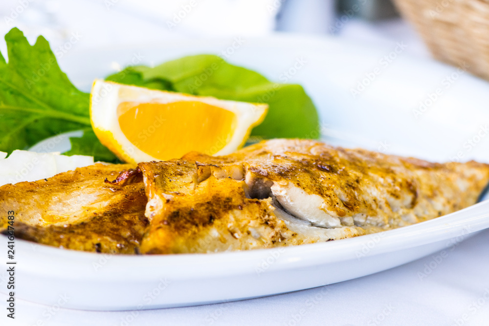 The trout fish served on the plate together with salat The trout fish served on the plate together with salat
