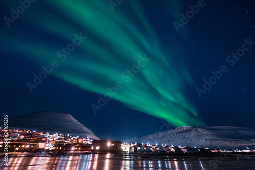 The polar arctic Northern lights aurora borealis sky star in Norway Svalbard in Longyearbyen the moon mountains photo