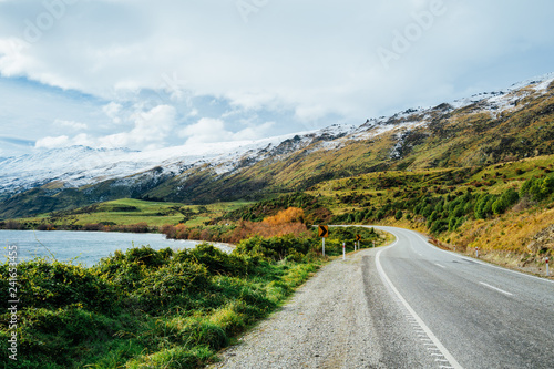 Long winding road leading to a snow capped mountain in New Zealand
