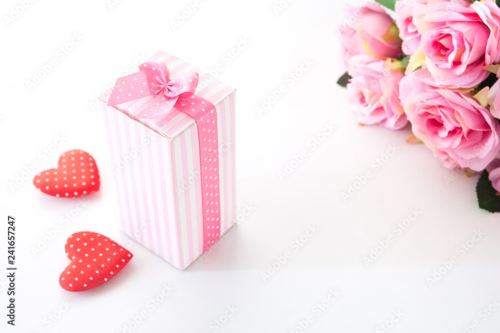 Close up gift box on white background with pink rose and heart on white background Close up gift box on white background with pink rose and heart on white background