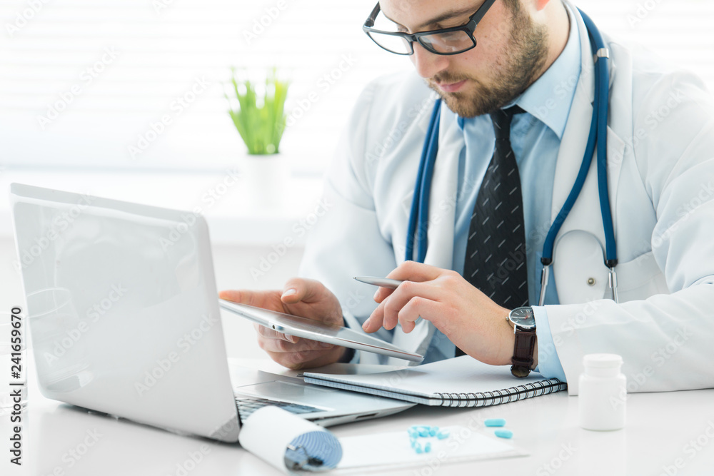 The doctor prescribes a prescription medication sitting in his office The doctor prescribes a prescription medication sitting in his office