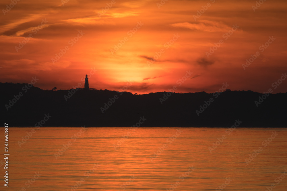 Sonnenuntergang über Insel Hiddensee mit Leuchtturm Dornbusch und Ostsee