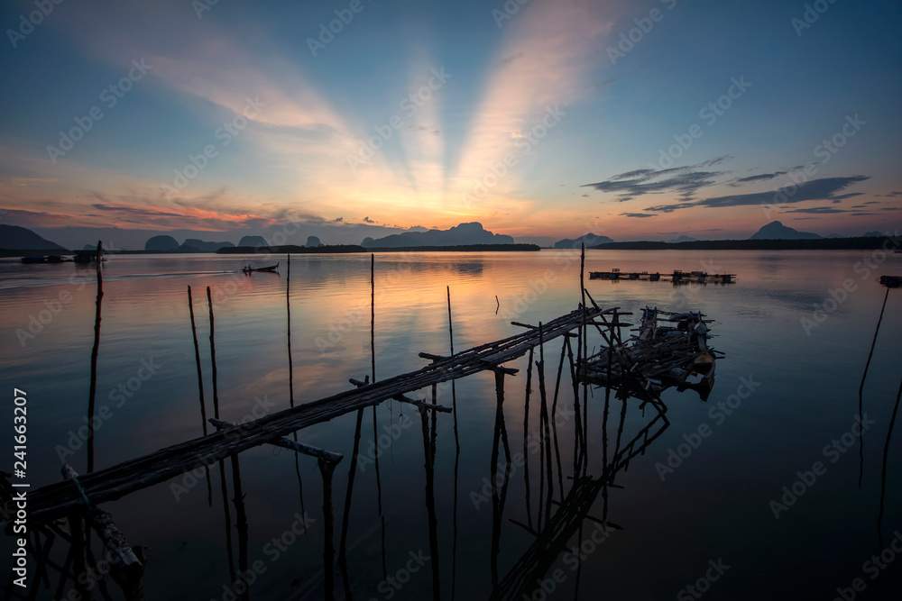 Old wooden bridge at sunrise time in Phangnga, Thailand.