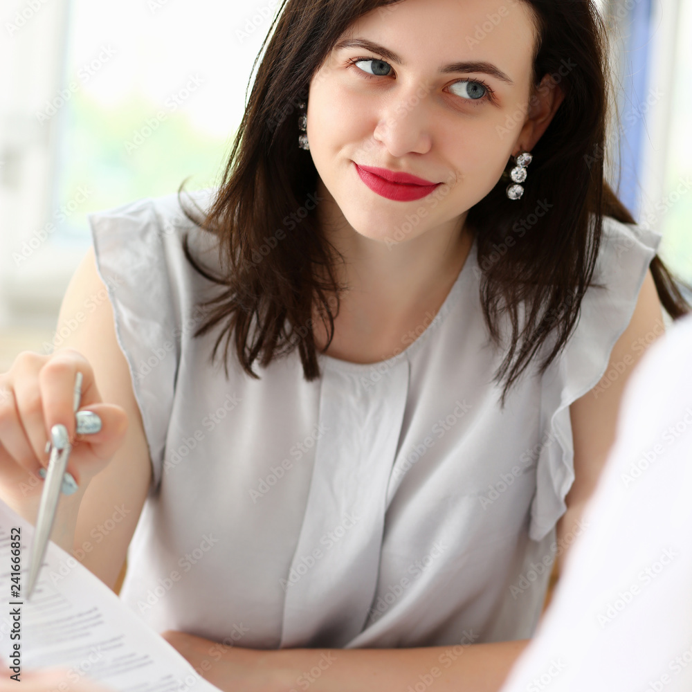 Beautiful woman portrait at workplace examining Beautiful woman portrait at workplace examining