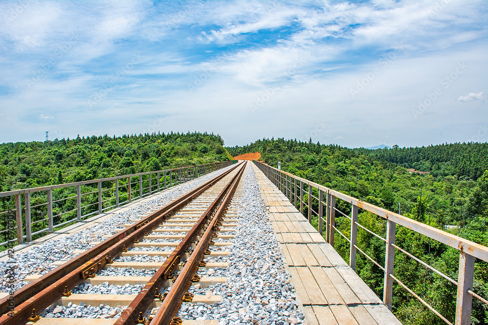 Railway train track under blue sky Railway train track under blue sky