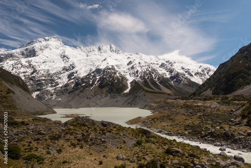 Hooker River emerging from Mueller lake. snow capped mountains and glaciers in the background. From the Hooker Valley Track, Aoraki/Mount Cook National Park New Zealand.