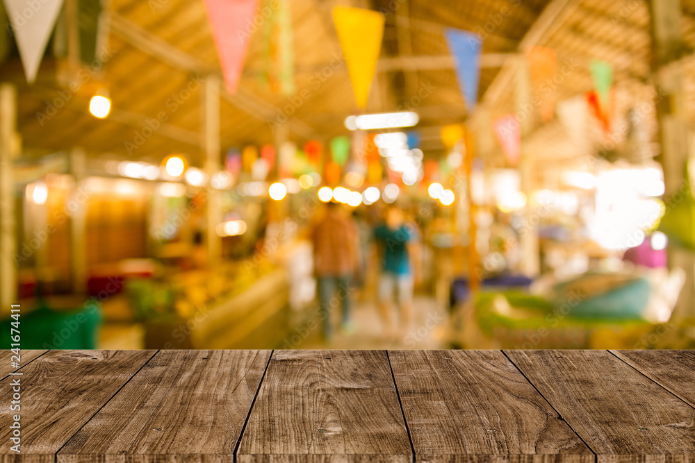 Blur festival background with wooden table top for product display montage. Blur festival background with wooden table top for product display montage.