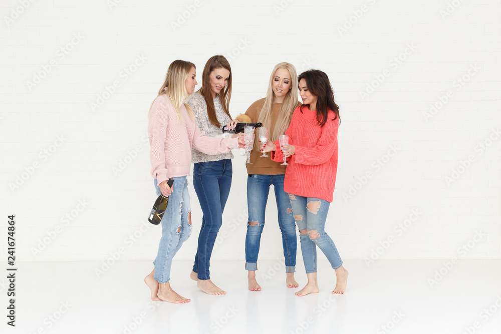 Fashion portrait of four women drinking champagne and having fun Fashion portrait of four women drinking champagne and having fun