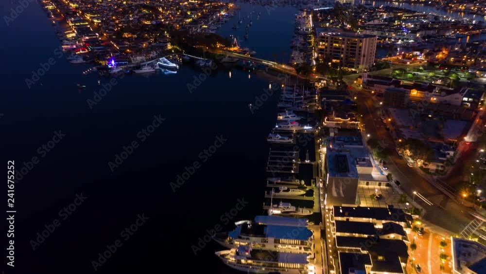 Cinematic urban aerial time lapse in motion from a drone above at night over traffic in coastal Orange County, California travel or vacation destination.