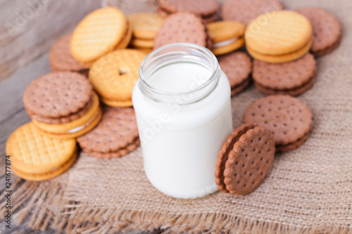 milk with cookies on a wooden background