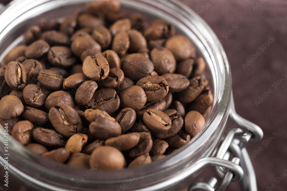 Fototapeta premium Glass jar with roasted coffee beans.
