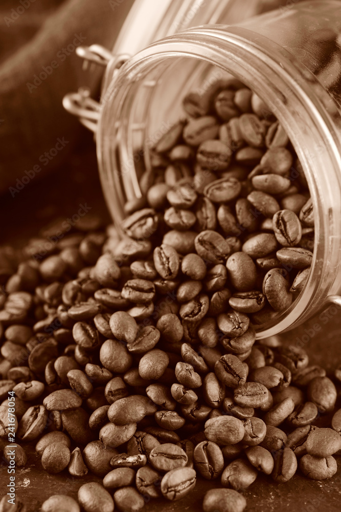 Fototapeta premium Coffee beans in glass jar. Toned photo