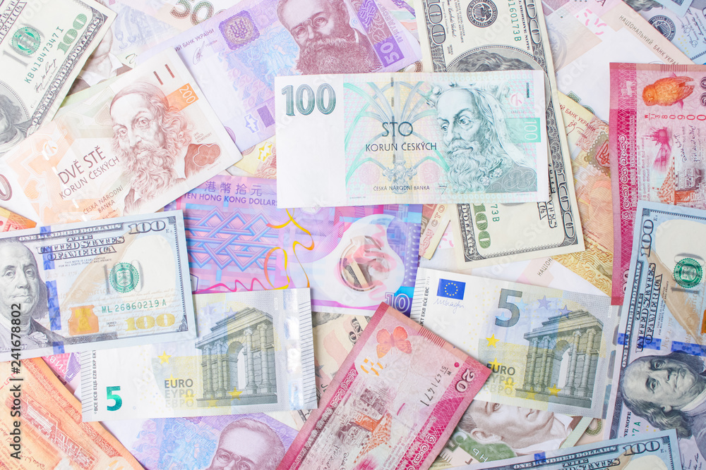 Close up on pile of many bank notes from various countries from around the world. U.S., German, Swiss, Canadian, Brazilian, Vietnamese, Mexican. Many countries represented in currency. Close up on pile of many bank notes from various countries from around the world. U.S., German, Swiss, Canadian, Brazilian, Vietnamese, Mexican. Many countries represented in currency.