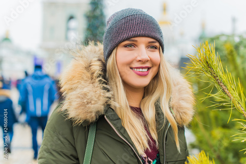 Portrait of attractive happy plus size young model in parka jacket casual style walk at city at winter day . Life of xl woman 