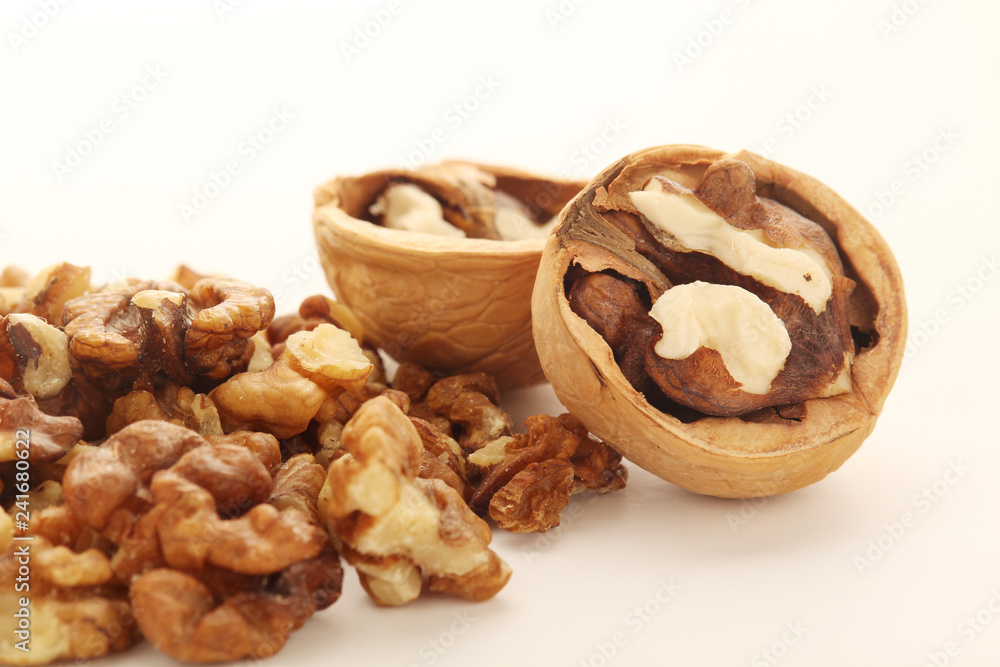 A pile of peeled walnuts at white background A pile of peeled walnuts at white background