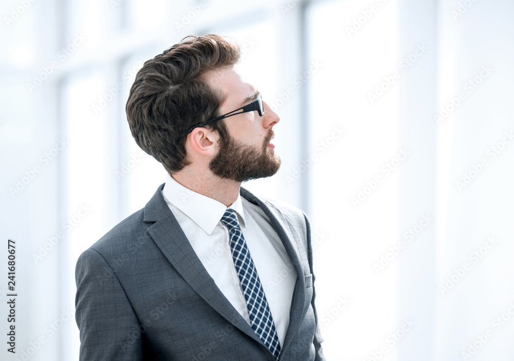 side view. businessman looking through office window side view. businessman looking through office window