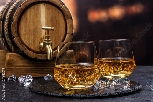 Fotografie Two glasses of Cognac with ice cubes