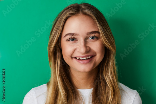 Smiling girl on green, portrait