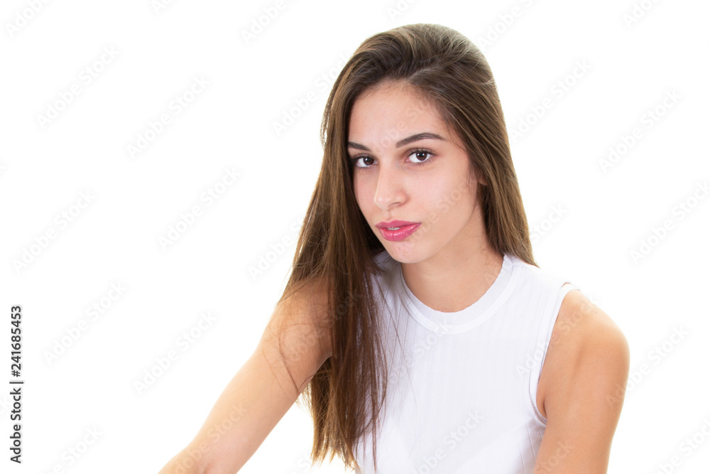 Calm serious caucasian pretty girl with hair brunette while standing over white background Calm serious caucasian pretty girl with hair brunette while standing over white background