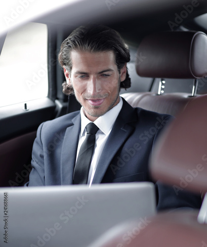man working on laptop while sitting in the car © ASDF