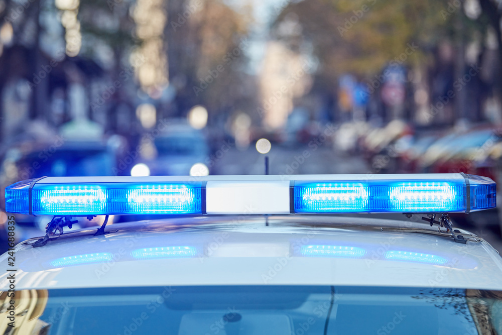 Police car with blue lights on the crime scene in traffic / urban ...