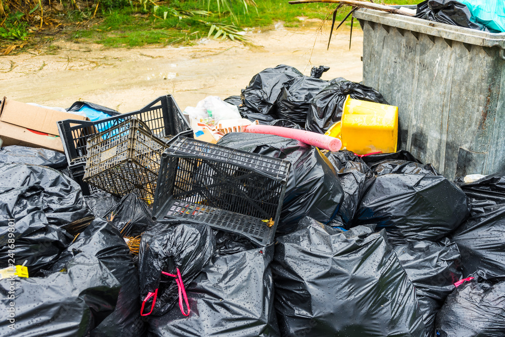 Junkyard of many plastic bags and other plastic trash in garden