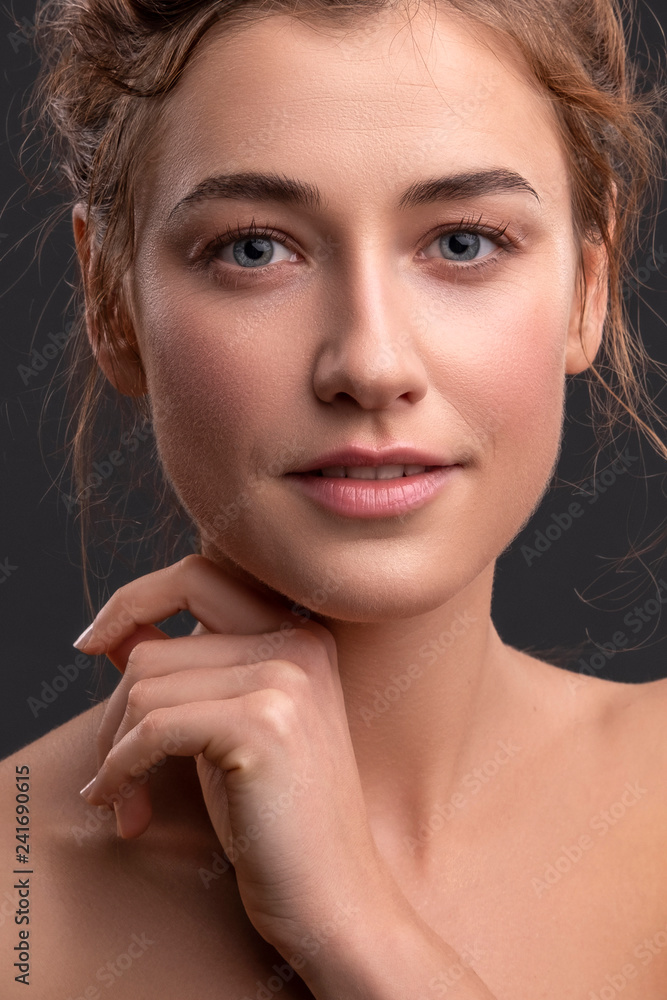 Cute smiling brunette caucasian woman posing on grey background. Fresh, clean, healthy, flawless skin. Space for text. Cute smiling brunette caucasian woman posing on grey background. Fresh, clean, healthy, flawless skin. Space for text.