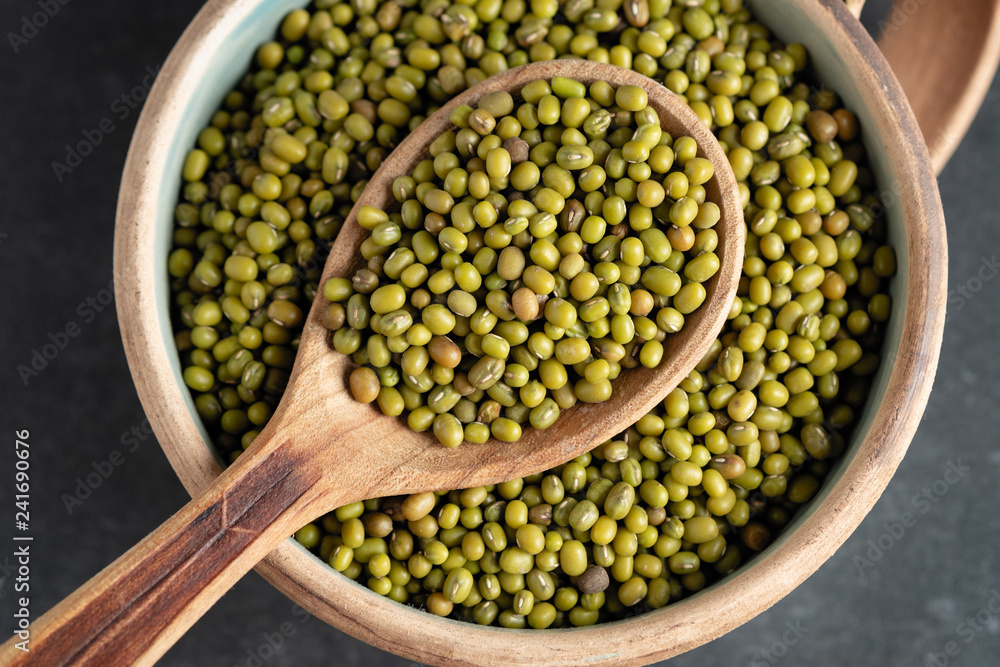 fresh mung beans in ceramic dishes against a dark stone background fresh mung beans in ceramic dishes against a dark stone background