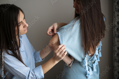 Wallpaper Mural Seamstress tries on tunic on woman Torontodigital.ca