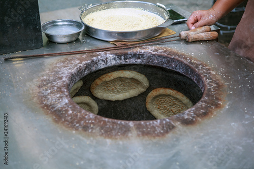 Baking bread cakes in a clay oven. Out of a traditional brick oven.