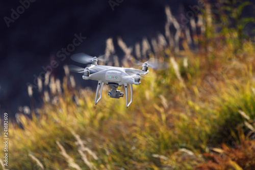 Drone flying over dramatically golden lit alpine autumn landscape