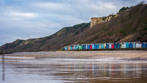 Beach Huts at the seaside with cliffs behind
