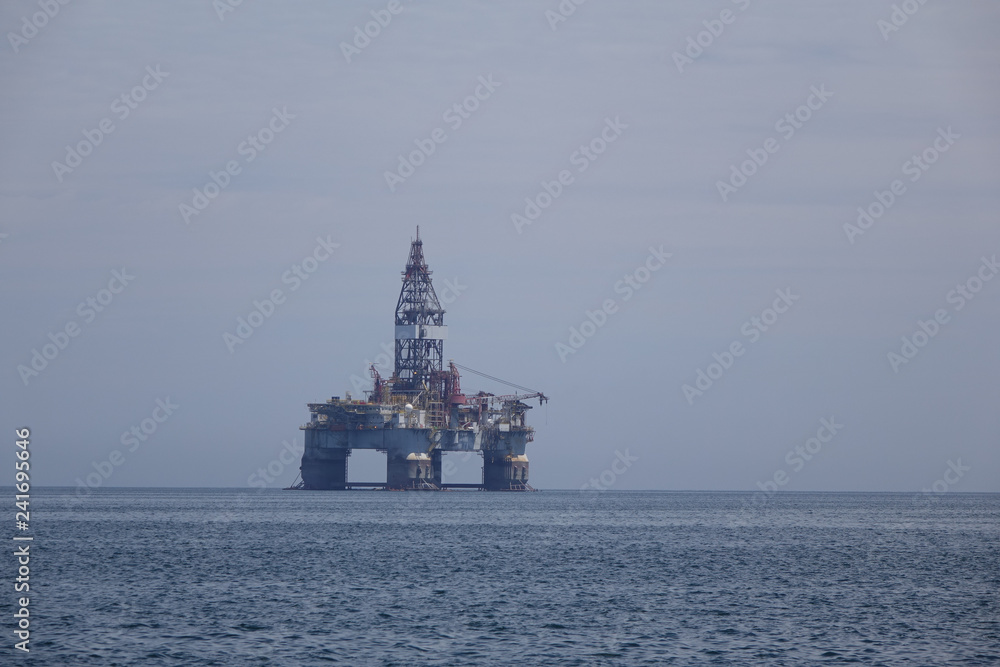 A oilrig drill platform anchored in the south Atlantic on a hazy day